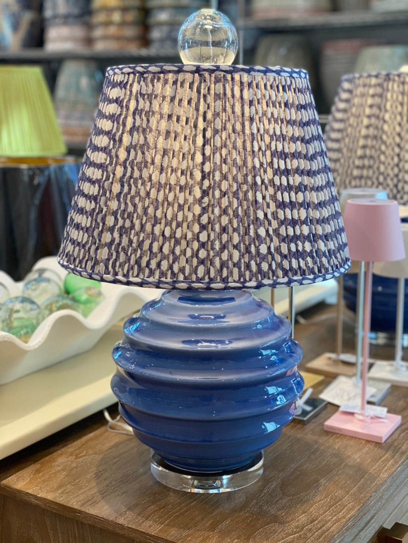 Large glass ball finial on a blue lamp and Fermoie lampshade