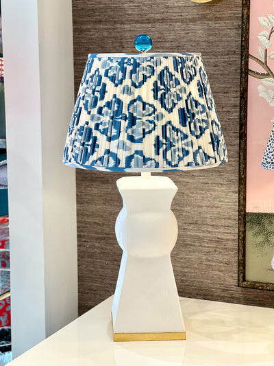 Blue and white ikat lampshade on a white lamp