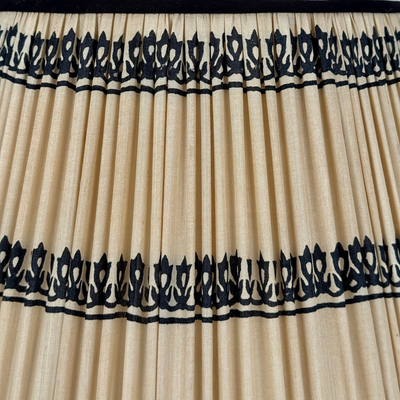 Beige pleated curtain with black decorative trim