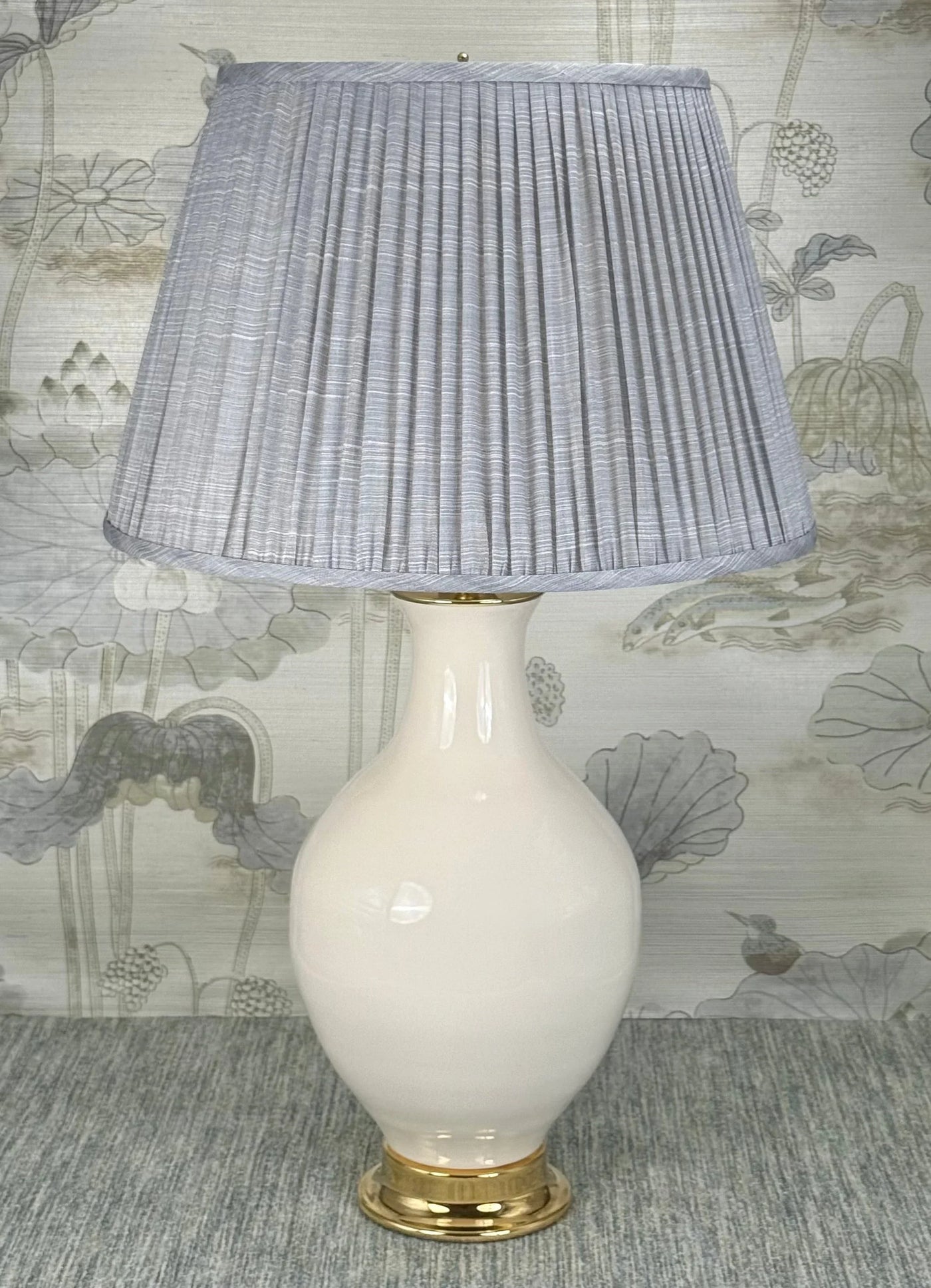 Column Style Brass Finial in Polished Brass styled with a Fermoie strie lampshade on a Paul Schneider Athens ceramic lamp