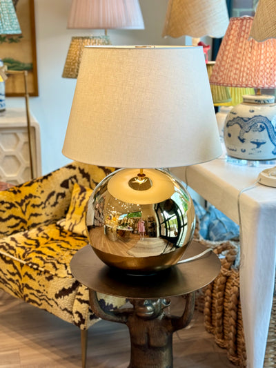 Gold sphere lamp and monkey table
