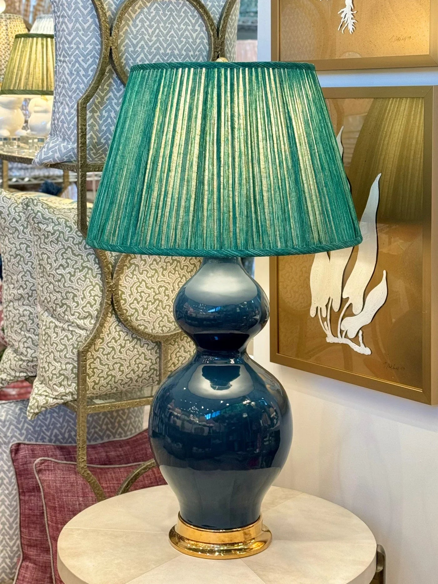Luxurious green pleated empire lampshade in Fermoie fabric displayed on a Paul Schneider blue ceramic lamp