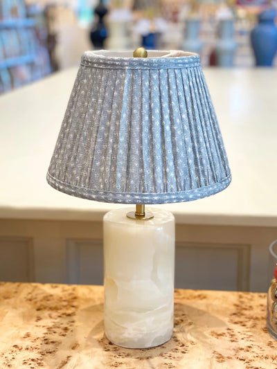 Fermoie blue figured pleated empire lampshade displayed on elegant Dauphine table and bedside lamps