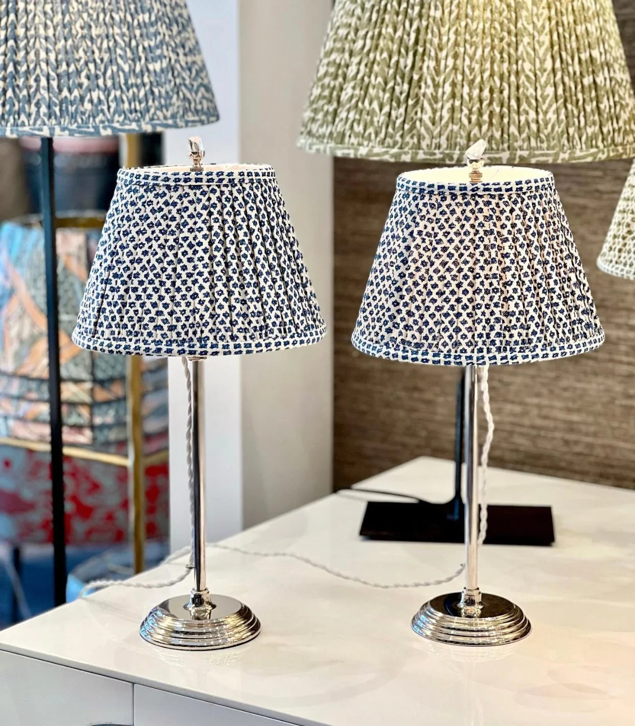 Pair of Fermoie Blue Marden gathered empire lampshades with a blue floral pattern displayed on matching silver table lamps, perfect for adding a touch of luxury to any space.