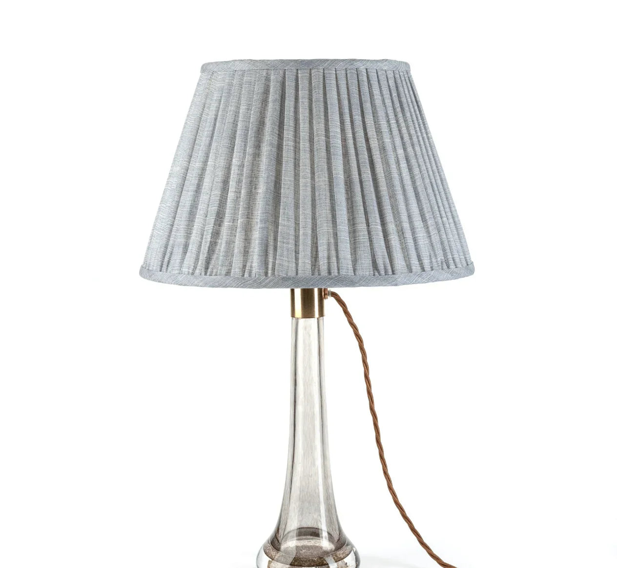 Luxury designer Fermoie Blue Moire gathered empire lampshade with pleated detailing displayed on a clear glass lamp base.