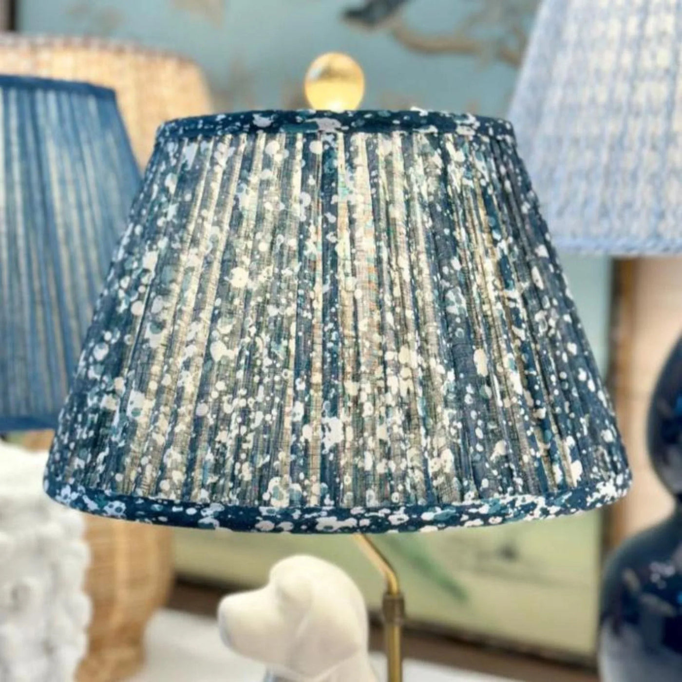 Close-up of luxury Fermoie Blue Quartz fabric with a speckled blue and white pattern, showing designer pleated detailing