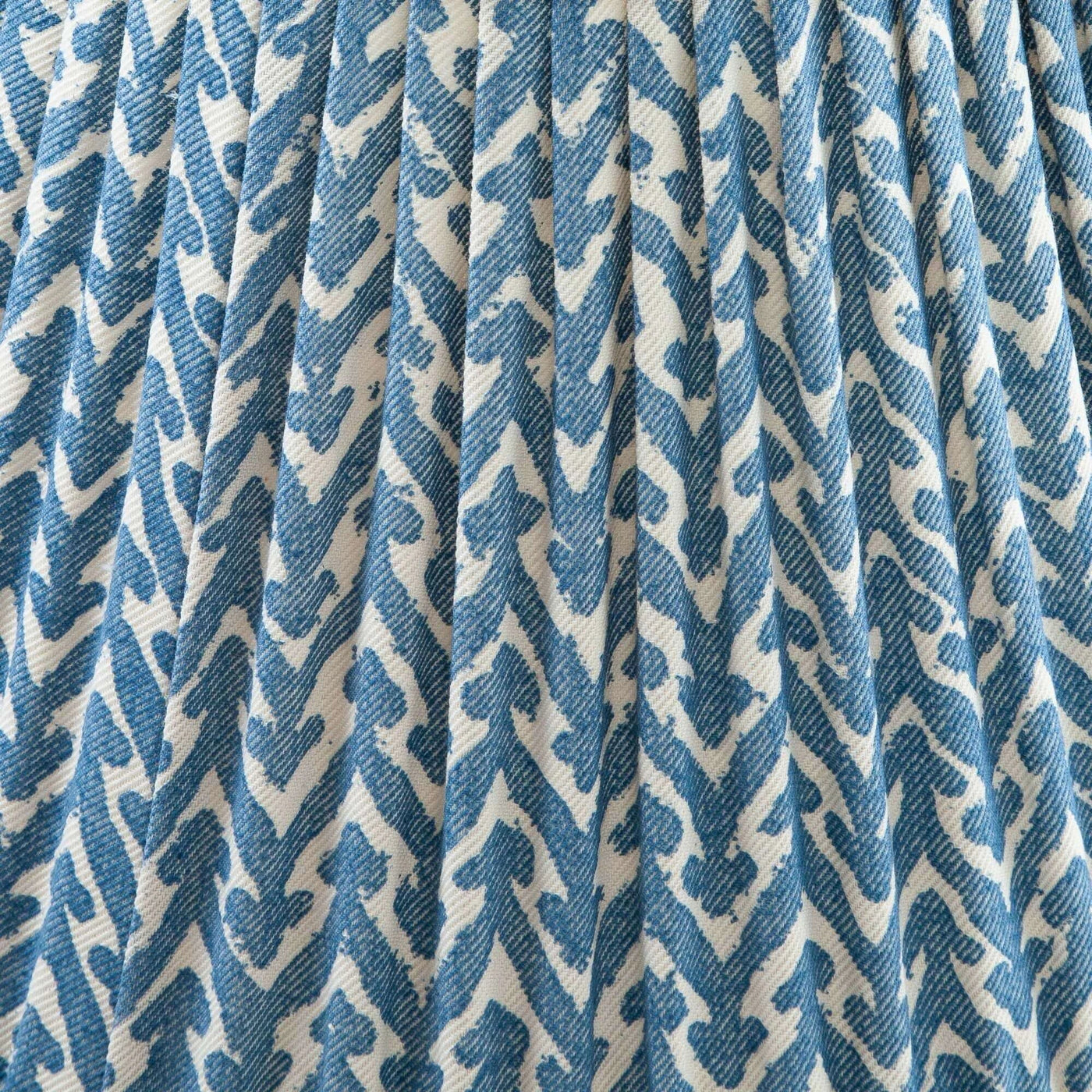 Close-up of Luxury designer Fermoie Blue Rabanna gathered empire lampshade with blue and white pattern and pleated detailing