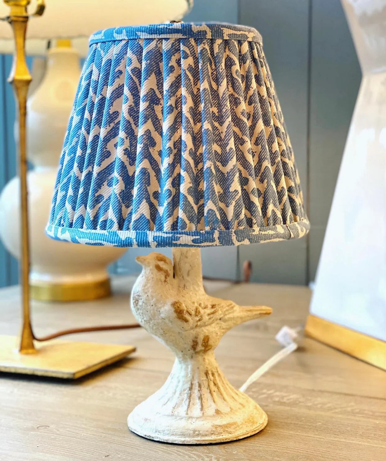 Luxury designer Fermoie Blue Rabanna gathered empire lampshade with pleated detailing displayed on a mini bird lamp