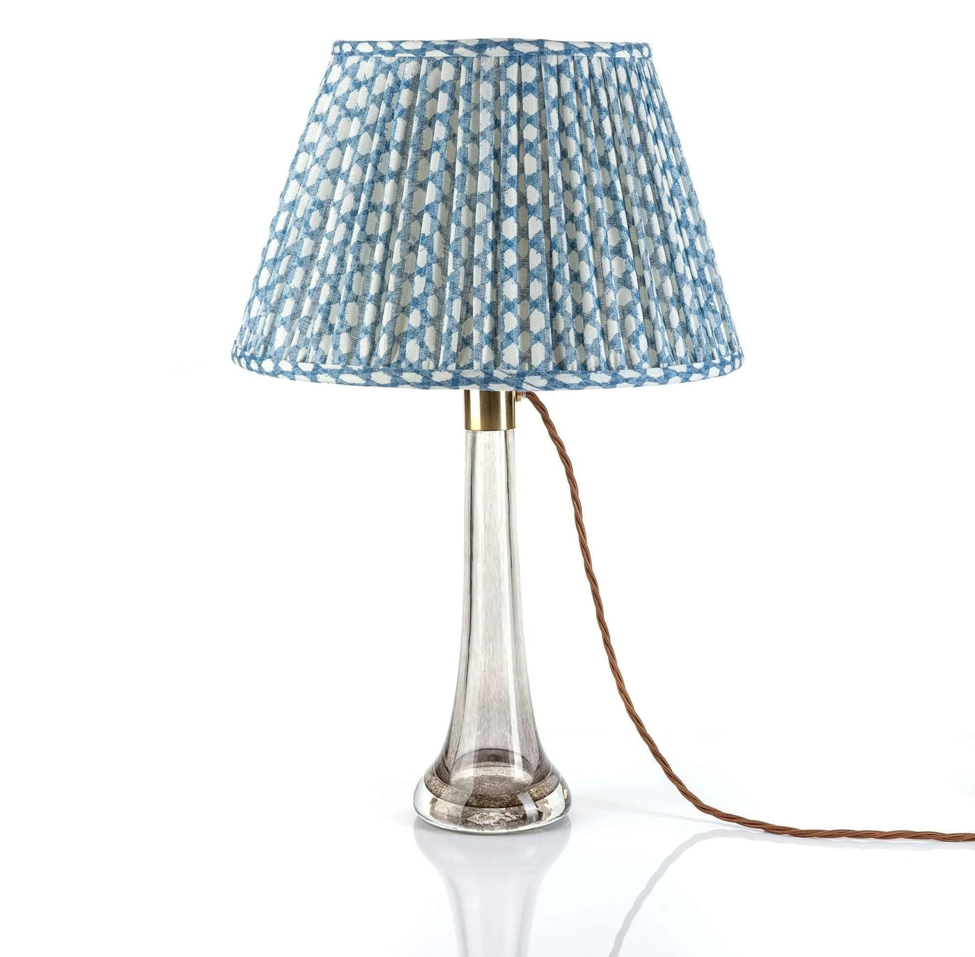 Luxury designer Fermoie Blue Wicker gathered empire lampshade with blue and white woven pattern displayed on a clear glass lamp