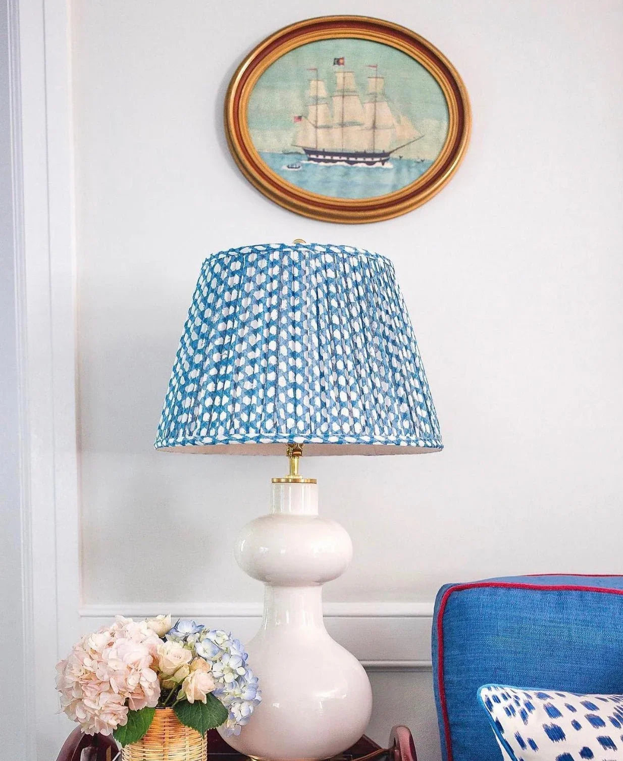 Luxury designer Fermoie Blue Wicker gathered empire lampshade with blue and white woven pattern on a white ceramic lamp