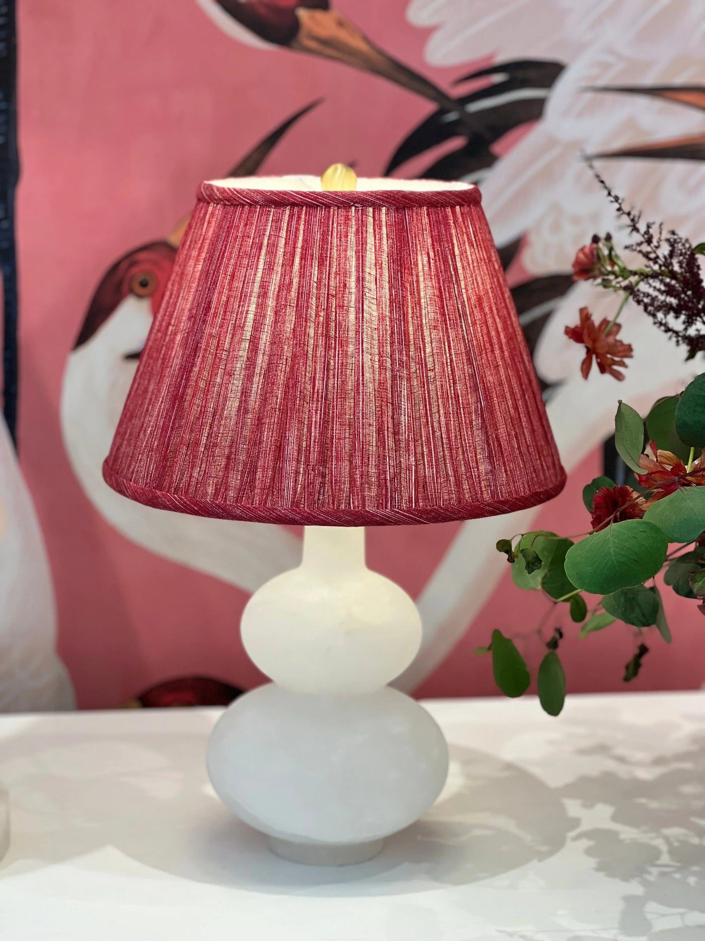 Luxury designer Fermoie Carpet Slipper gathered empire lampshade in a rich red hue, displayed on an Alabaster Lamp