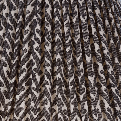 Close-up of Fermoie Charcoal Rabanna fabric with a textured charcoal and cream pattern and pleated detailing