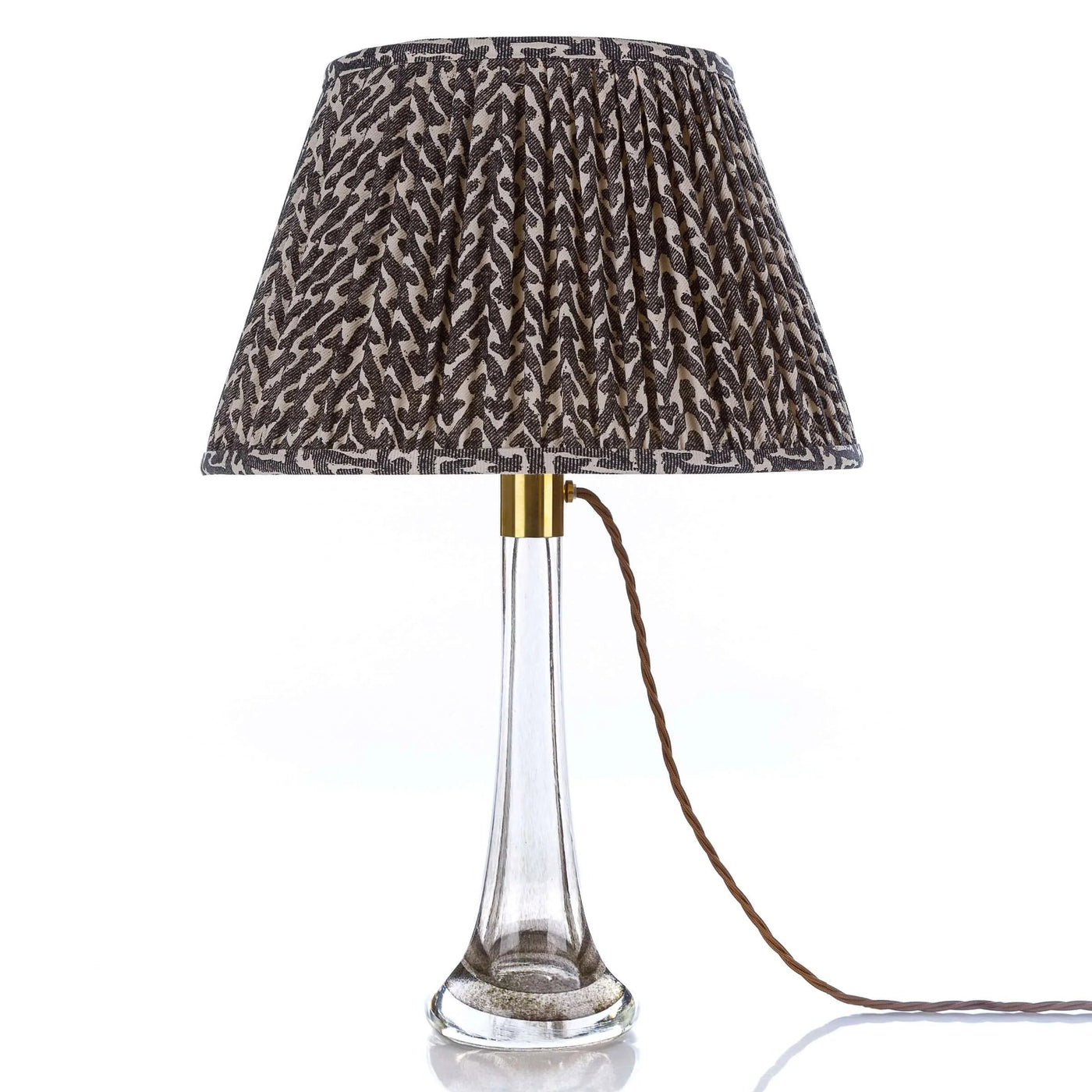 Designer Fermoie Charcoal Rabanna gathered empire lampshade, featuring a textured charcoal and cream pattern displayed on a clear glass lamp 