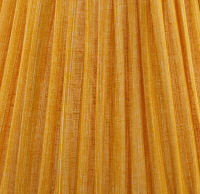 Close-up of Fermoie golden yellow fabric with pleated detailing, highlighting the rich texture and handcrafted quality