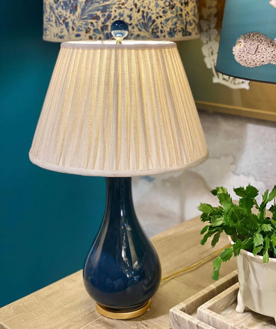 Luxury designer Fermoie Cream Moire empire lampshade with pleated white cream linen fabric displayed on blue lamp