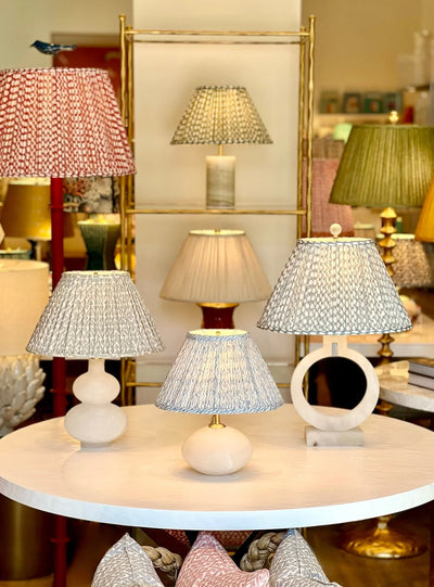 Fermoie oval lampshades on alabaster lamps