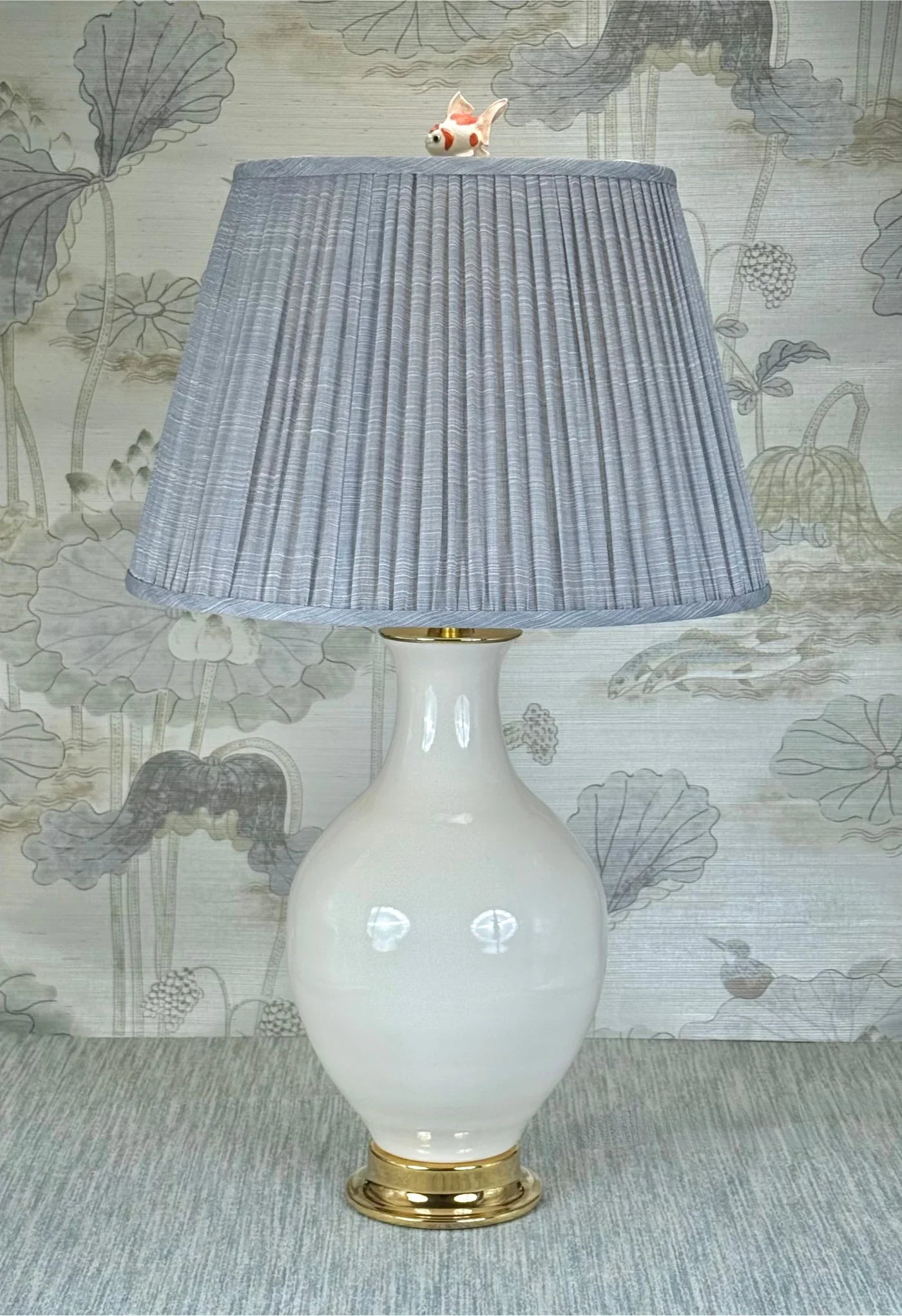Goldfish lamp finial styled with a Fermoie strie lampshade on a Paul Schneider Athens ceramic lamp.