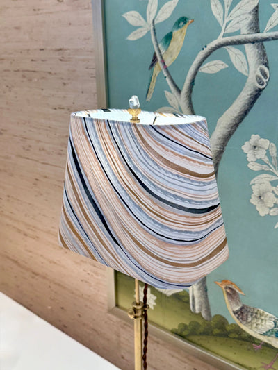 Rectangular lamp shade with hand-painted marble wallpaper in gold, blue, and grey styled on lamp