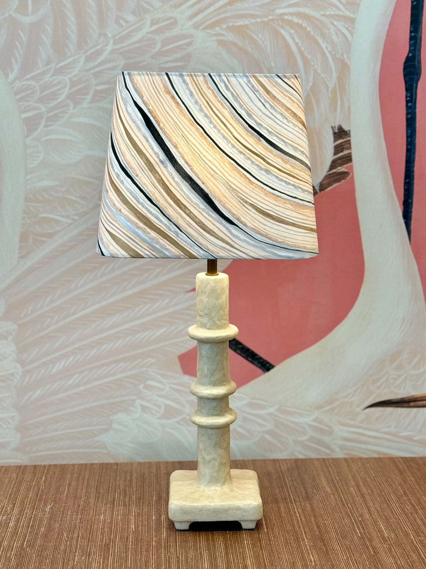 Rectangular lamp shade with hand-painted marble wallpaper in gold, blue, and grey styled on table lamp