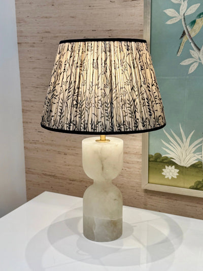 Taupe silk lamp shade with black trim on alabaster lamp 