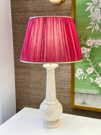 Pleated pink silk lamp shade with champagne-colored trim