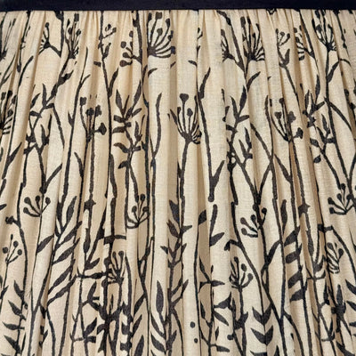 Detail of pleated taupe silk lamp shade with black floral design