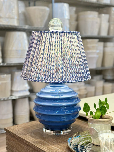 Fermoie Indigo Wicker Lampshade on a Blue Lamp