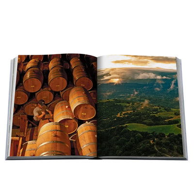 Open book showing images of stacked wine barrels and a scenic landscape.