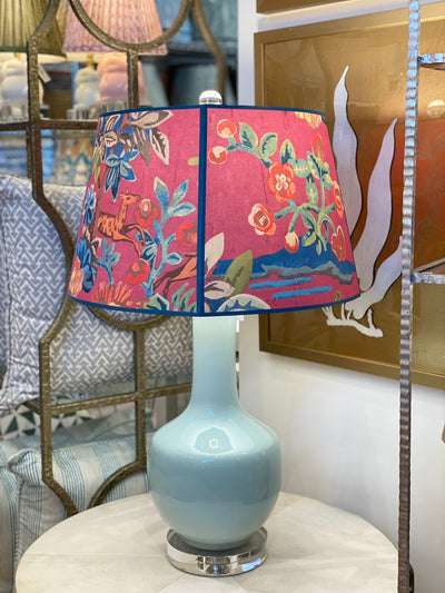 Pink Kit Kemp lampshade on a blue lamp