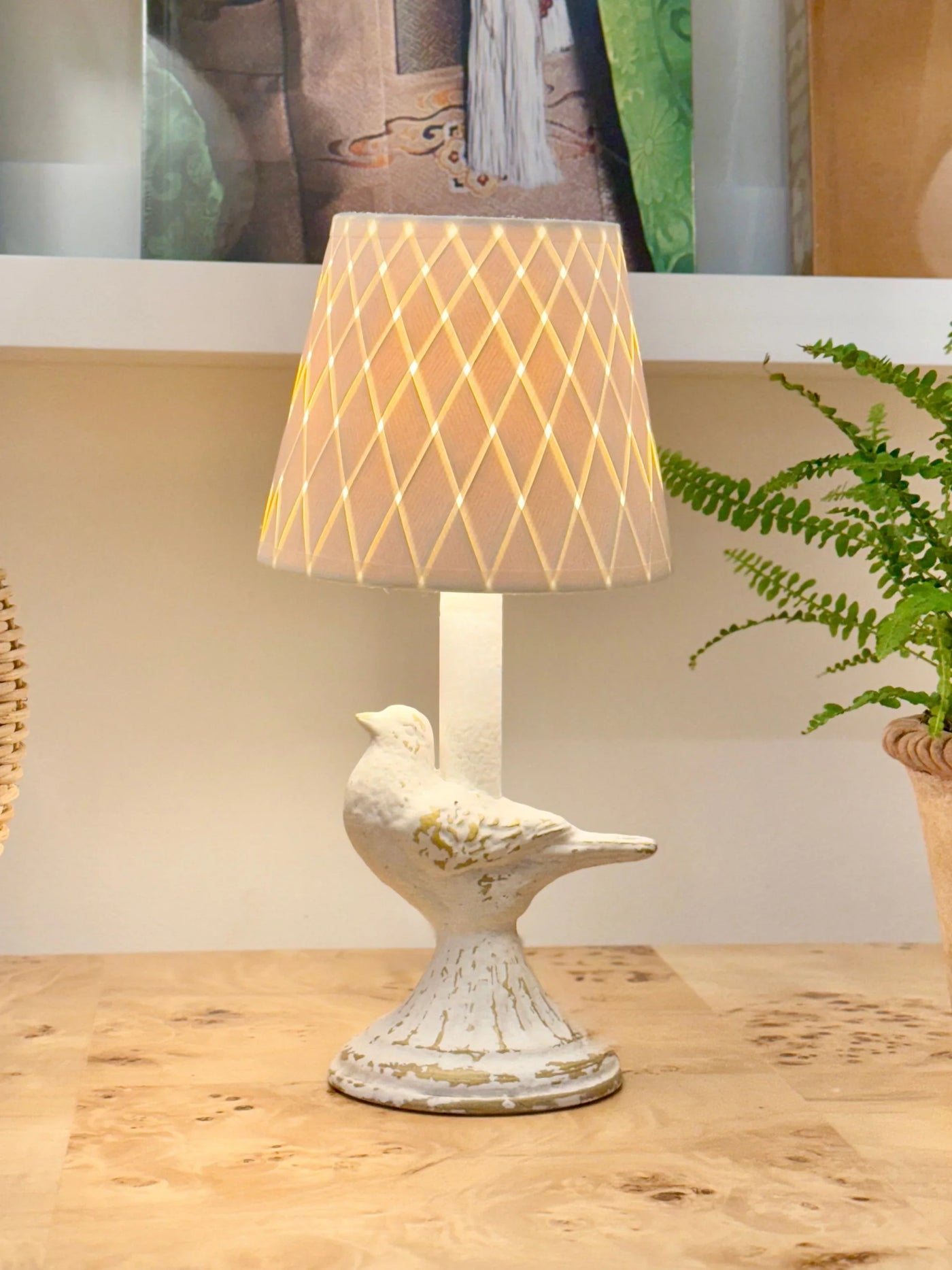 Decorative table lamp with a bird design on a wooden surface
