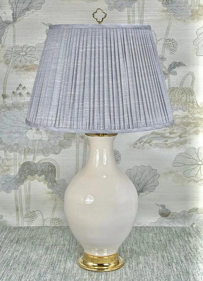 Polished Brass Circle lamp finial styled with a Fermoie strie lampshade on a Paul Schneider Athens ceramic lamp.