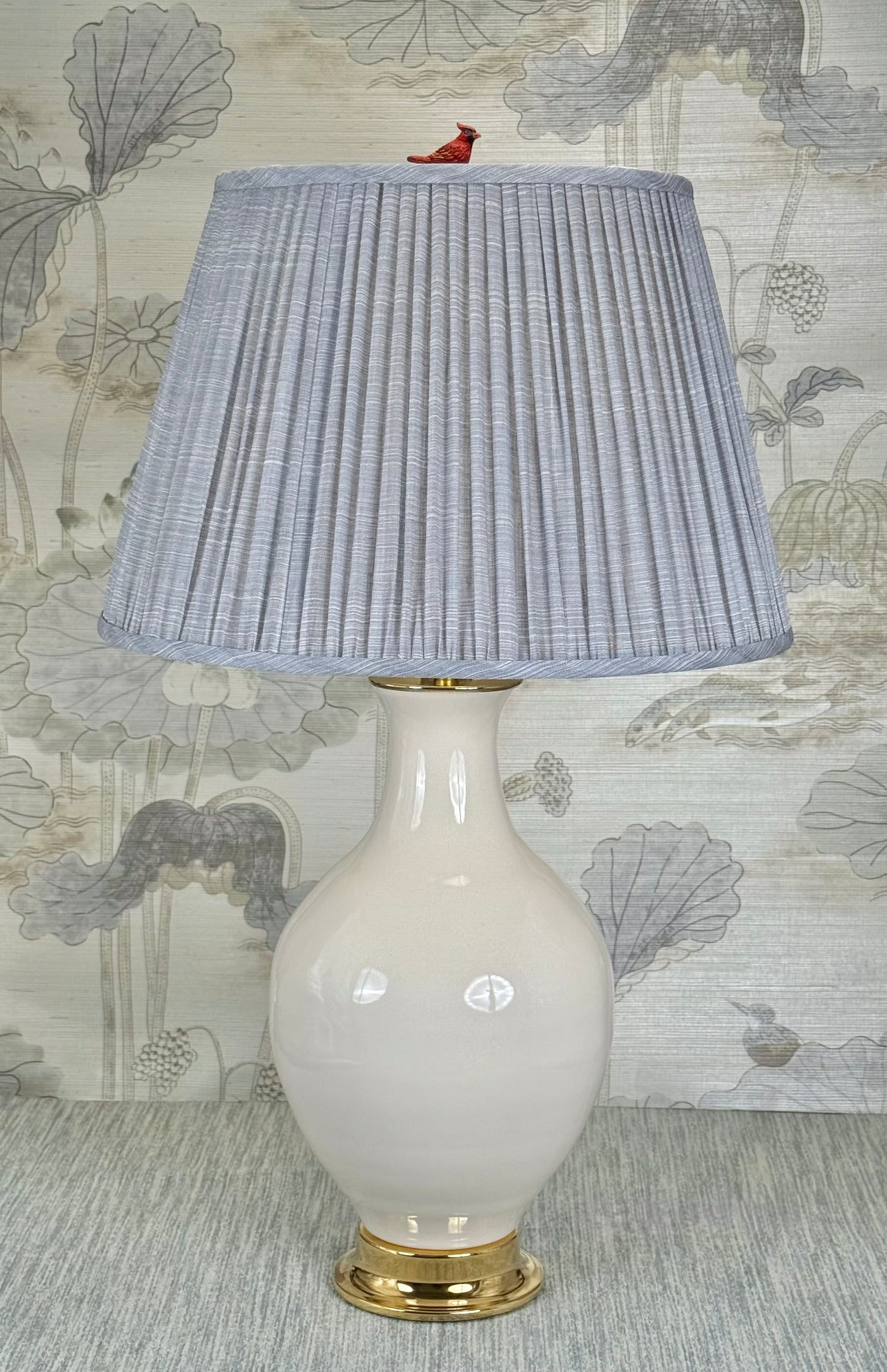 red cardinal lamp finial styled with a Fermoie strie lampshade on a Paul Schneider Athens ceramic lamp.