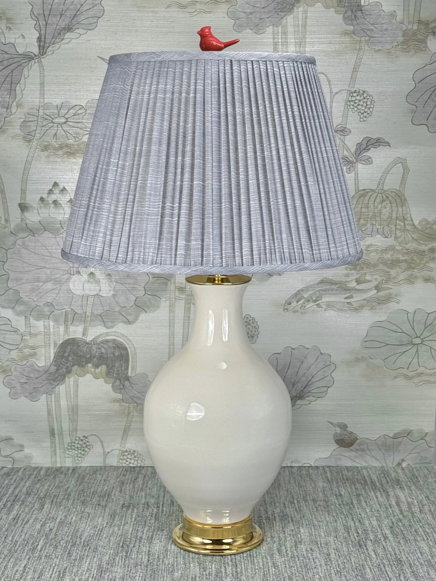 Red Porcelain Bird  lamp finial styled with a Fermoie strie lampshade on a Paul Schneider Athens ceramic lamp