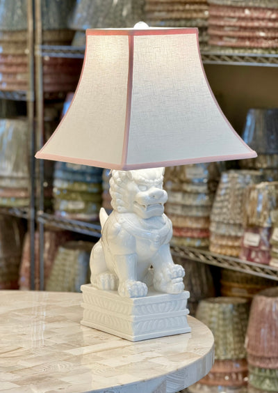 White Linen Square Bell Lampshade with Pink Trim paired with Porcelain White Foo Dog Table Lamp