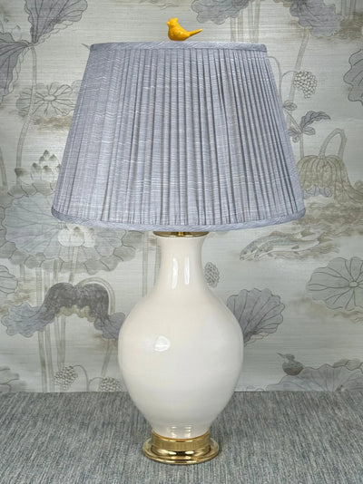 Yellow Porcelain Bird  lamp finial styled with a Fermoie strie lampshade on a Paul Schneider Athens ceramic lamp