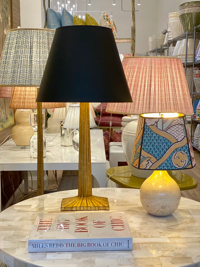 black parchment lamp shade on a gold lamp