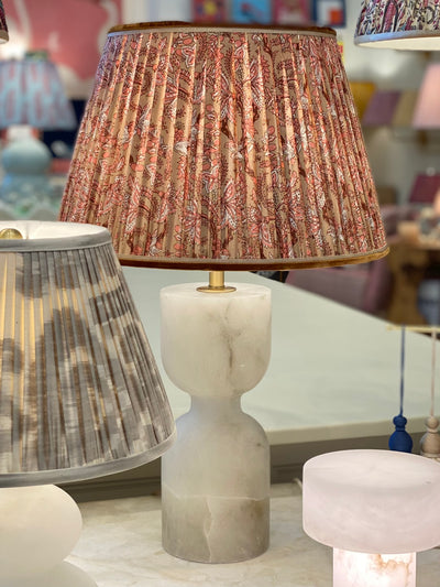 Brown block print lampshade on an alabaster lamp