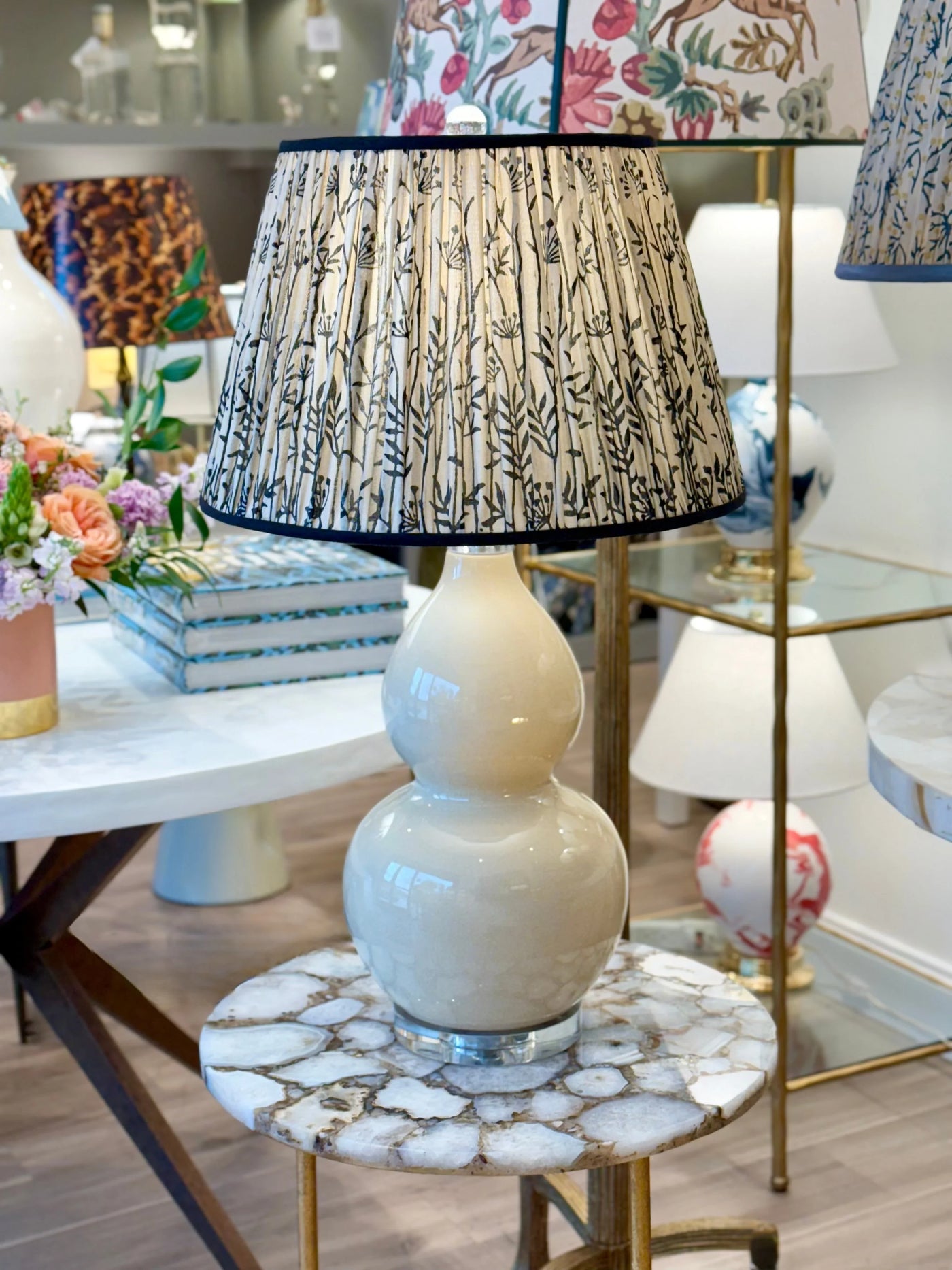 Taupe and black lamp shade styled on white table lamp 