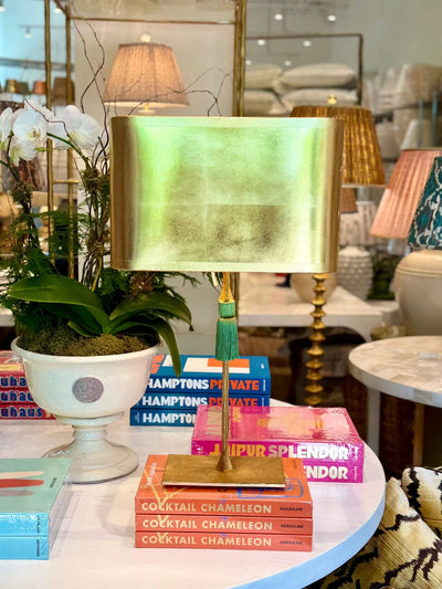 Dauphine Bedside Lamp with a gold lampshade and a green tassel