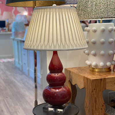 Full smocked silk chandelier lampshade on a red lamp