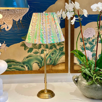 pink and green marbled paper lamp shade on a brass lamp