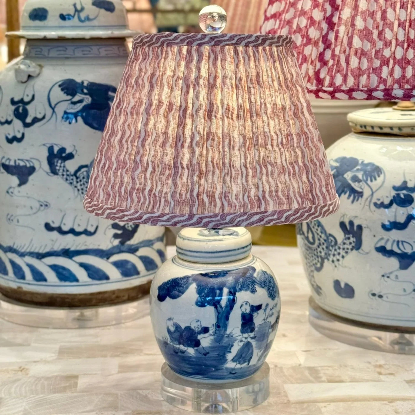 pink fermoie lampshade on a mini blue and white lamp