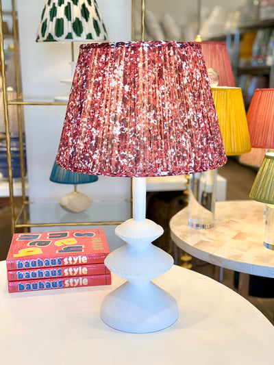 Red Fermoie Lampshade on a white table lamp