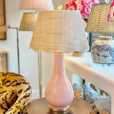 Scalloped raffia lampshade on a pink lamp