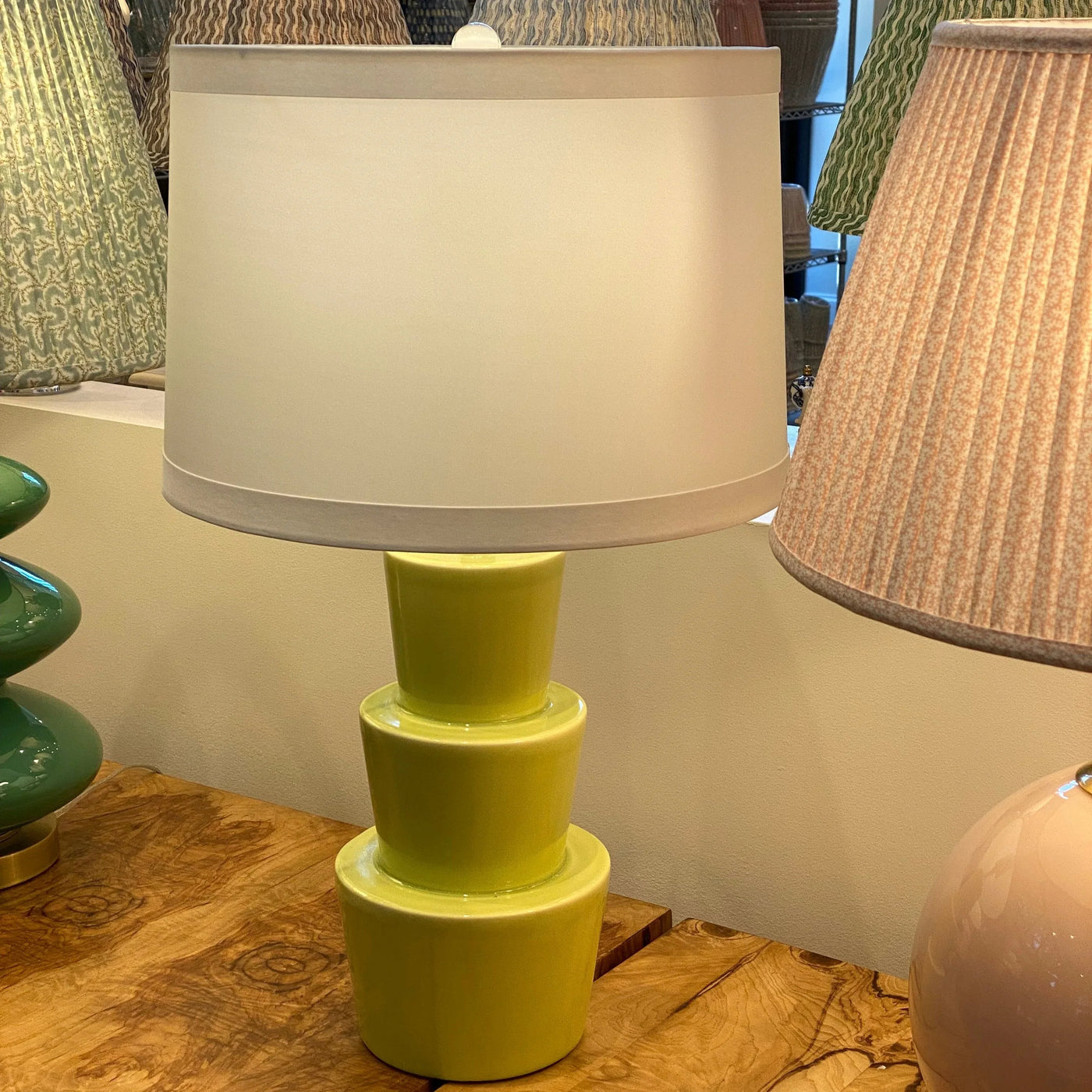 Silk banded drum lampshade on a green lamp