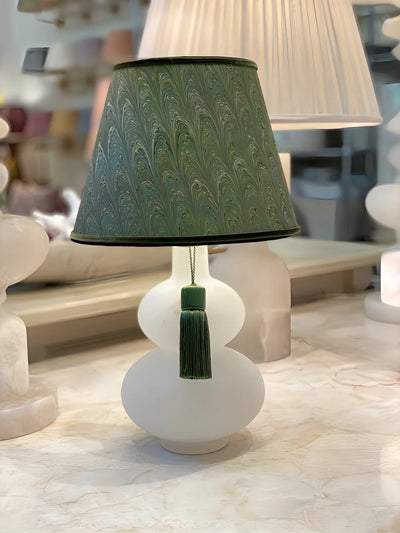 handmade Marbled paper lampshade on an alabaster lamp with a green tassel