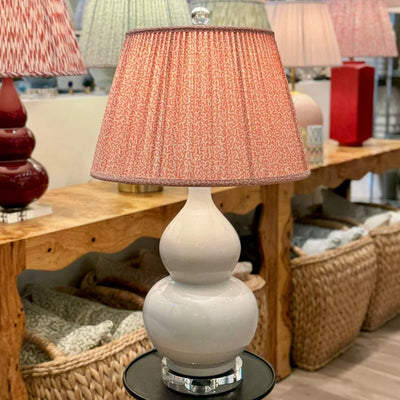 Pink lampshade on a white double gourd lamp