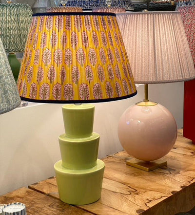 Yellow block print lampshade on a green lamp