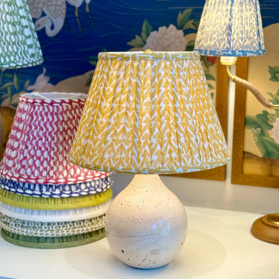 Fermoie Yellow Rabanna Lampshade on a travertine lamp