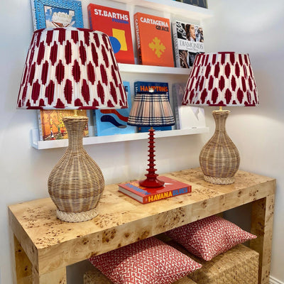 Red and white ikat lampshades on rattan lamps